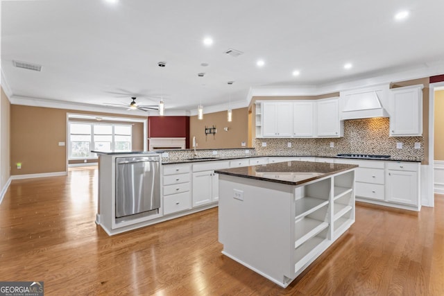 kitchen featuring white cabinetry, premium range hood, kitchen peninsula, and a kitchen island