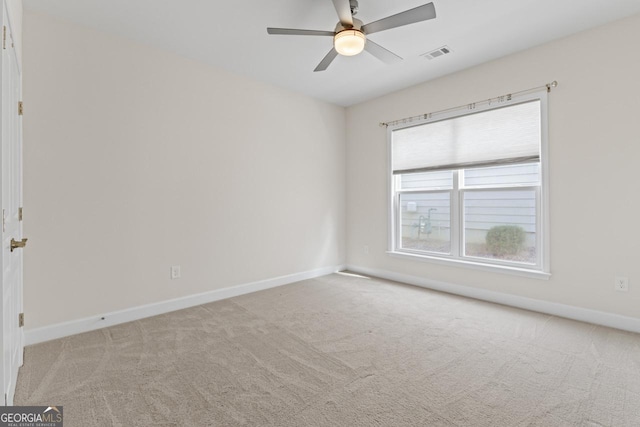 carpeted empty room featuring ceiling fan