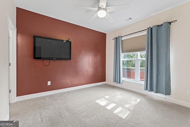 carpeted spare room featuring ceiling fan