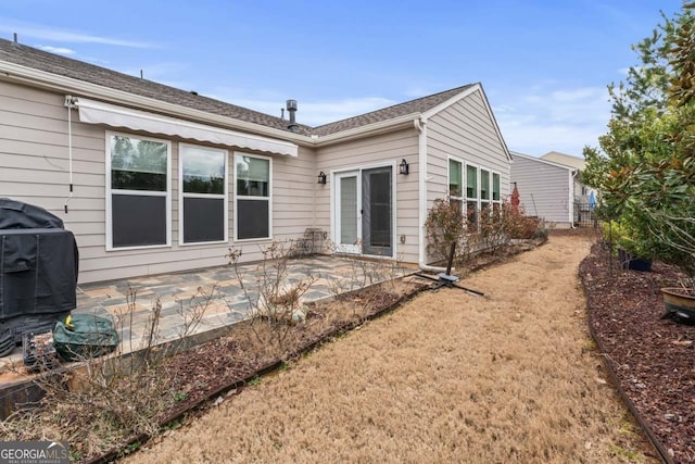 back of property with a patio