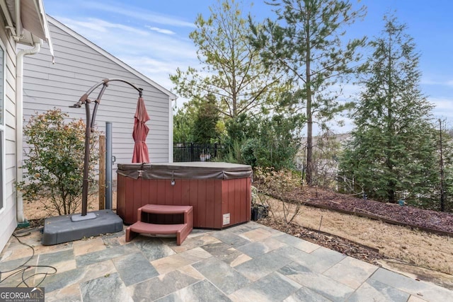 view of patio / terrace with a hot tub