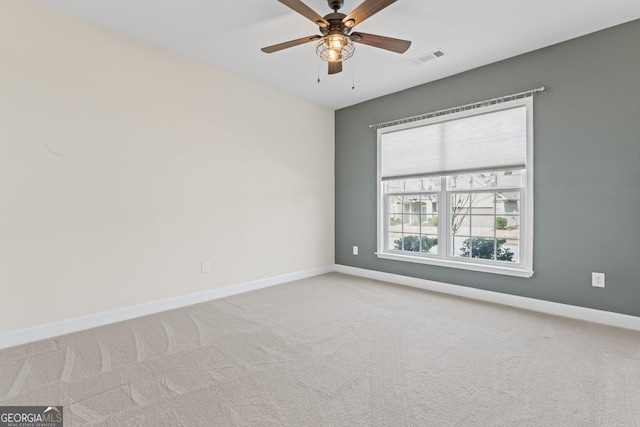 empty room featuring carpet floors and ceiling fan