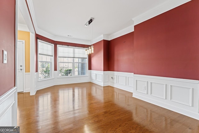 unfurnished room with crown molding and wood-type flooring