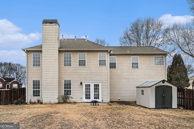 back of house featuring french doors and a storage shed