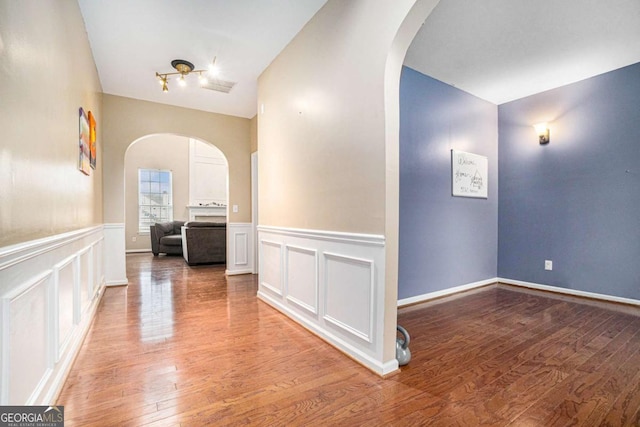 hall with hardwood / wood-style floors