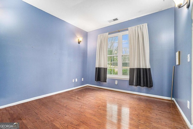 spare room featuring hardwood / wood-style flooring