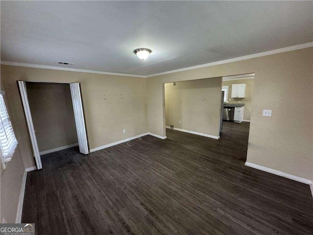 empty room with dark hardwood / wood-style flooring and ornamental molding