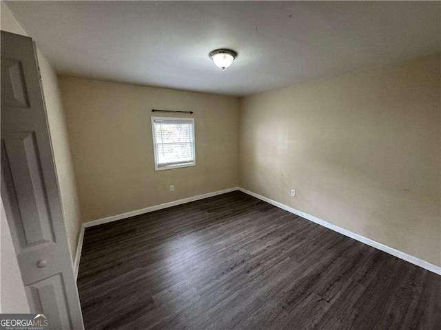 empty room with dark hardwood / wood-style floors