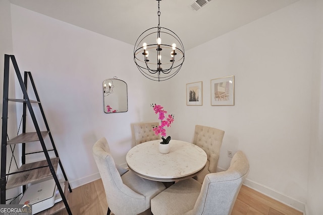 dining area featuring a chandelier and hardwood / wood-style floors