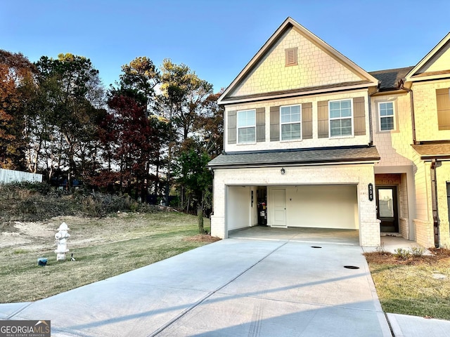 view of front of house with a garage and a front lawn