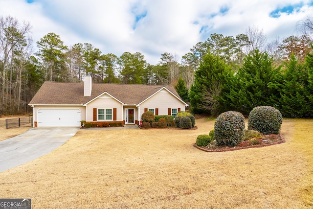 ranch-style home featuring a garage and a front lawn