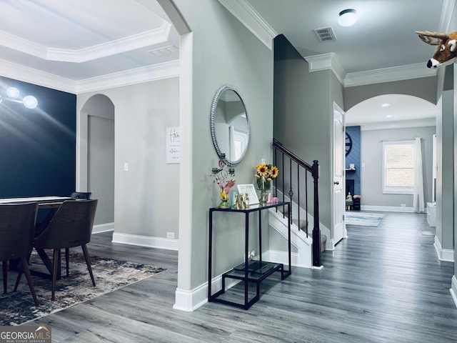 hall with dark wood-type flooring and ornamental molding