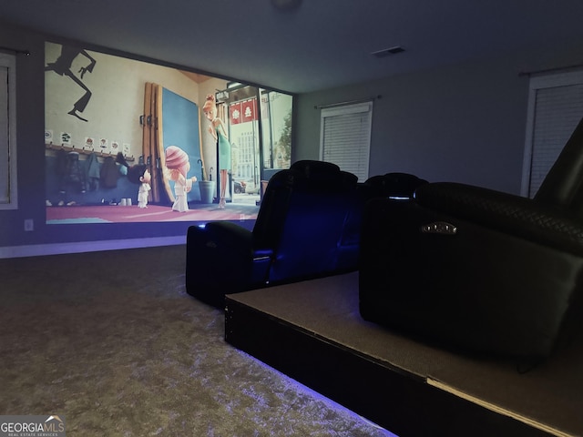 carpeted cinema room featuring visible vents