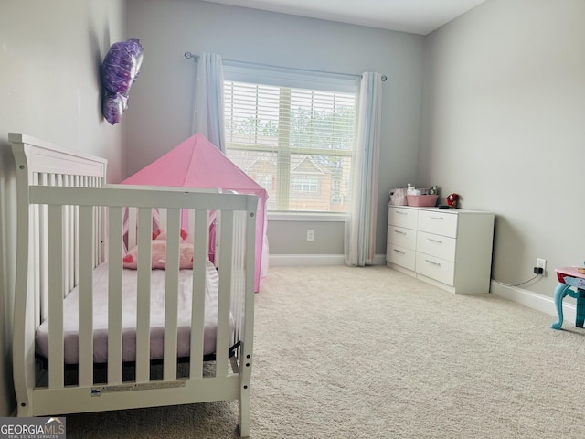 carpeted bedroom with a crib