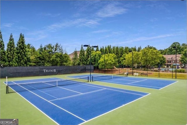 view of tennis court with fence