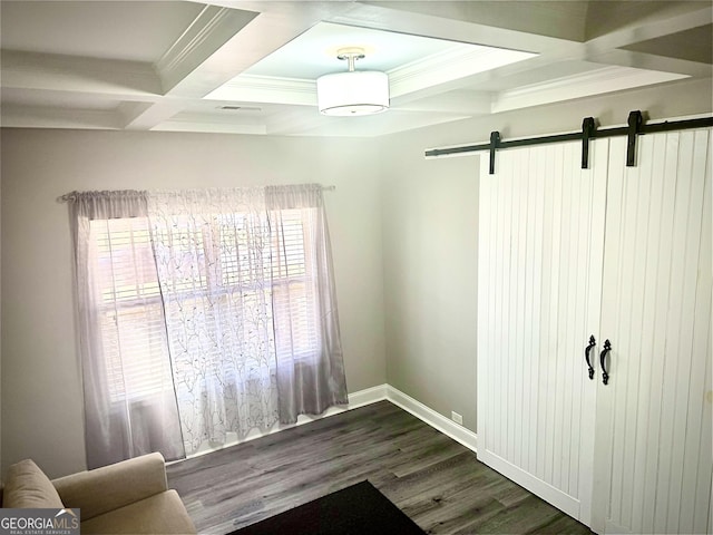 interior space with dark wood-style flooring, coffered ceiling, beam ceiling, and a barn door