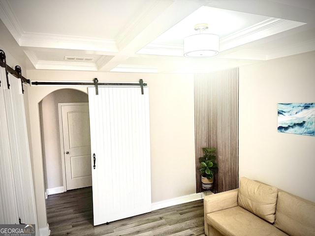 sitting room with a barn door, coffered ceiling, wood finished floors, and visible vents