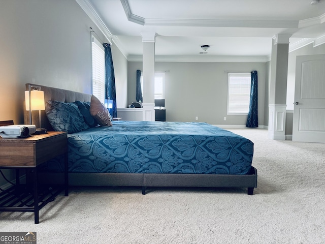 carpeted bedroom featuring ornamental molding and decorative columns