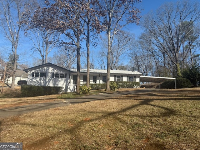 single story home with a carport and a front yard