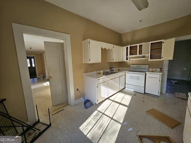 kitchen with white electric stove, sink, and white cabinets