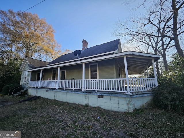 rear view of property featuring a porch