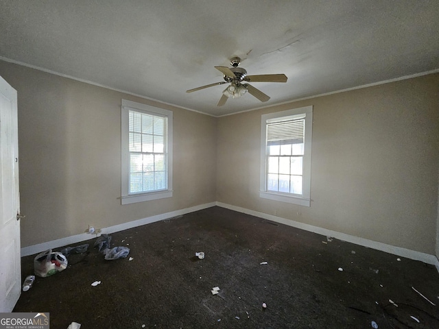 spare room with crown molding and ceiling fan