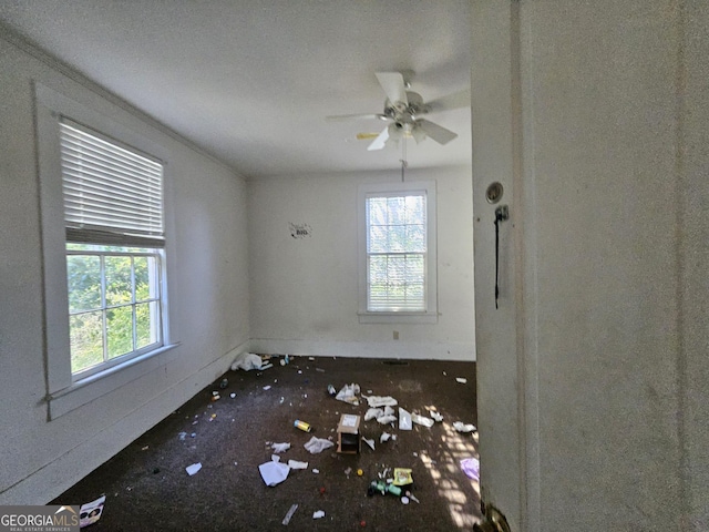 empty room with ceiling fan and a healthy amount of sunlight