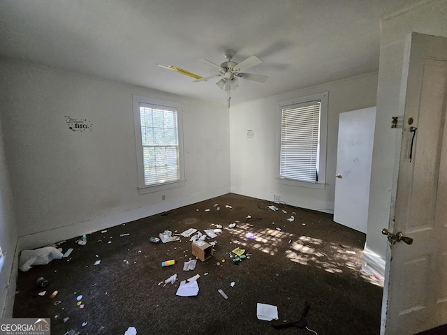 interior space with ceiling fan