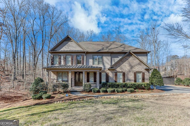 view of front of house featuring covered porch and a front lawn