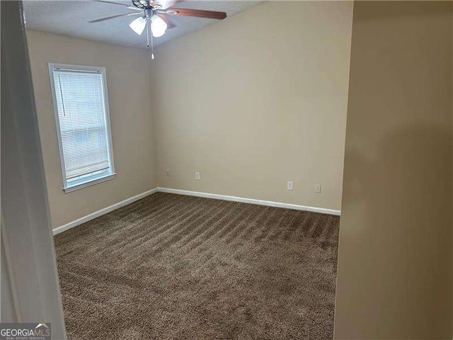 carpeted spare room featuring ceiling fan