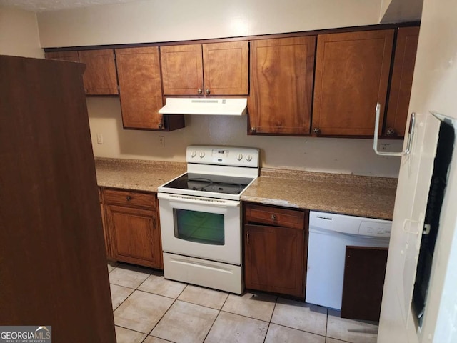 kitchen with light tile patterned floors and white appliances