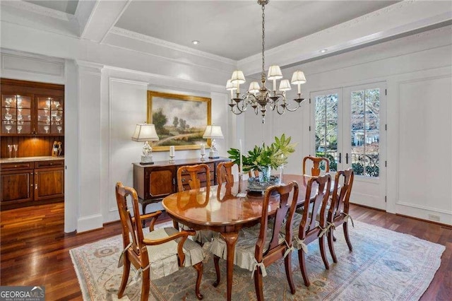 dining space with beam ceiling, crown molding, a chandelier, and dark hardwood / wood-style flooring