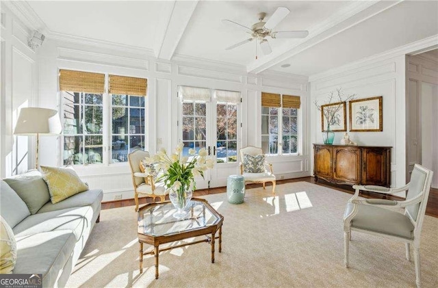 sunroom / solarium with beamed ceiling, ceiling fan, and french doors