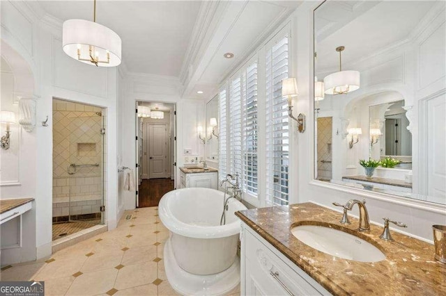 bathroom with tile patterned flooring, ornamental molding, vanity, and plus walk in shower