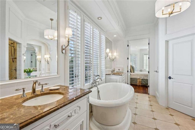 bathroom featuring ornamental molding, a bath, and vanity