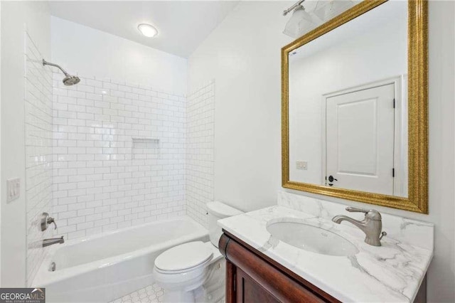 full bathroom with tiled shower / bath combo, vanity, and toilet