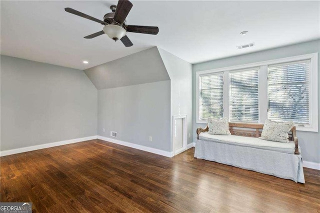 unfurnished room with dark hardwood / wood-style flooring, vaulted ceiling, and ceiling fan