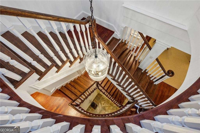 stairs featuring hardwood / wood-style flooring