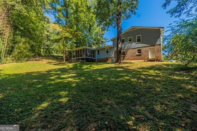 view of yard featuring a sunroom