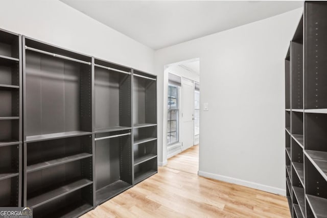 spacious closet featuring hardwood / wood-style floors