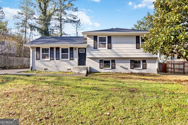 tri-level home with a front yard