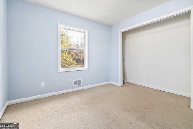 unfurnished room with light carpet