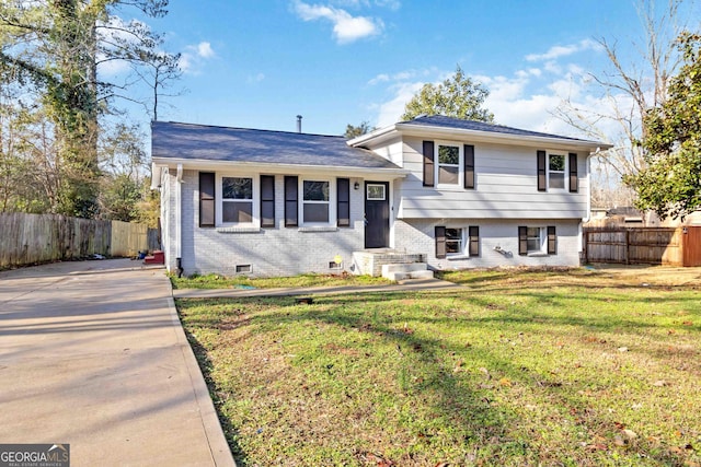 split level home featuring a front lawn