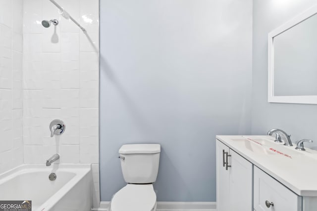 full bathroom featuring tiled shower / bath, vanity, and toilet