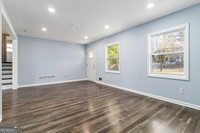 empty room with dark wood-type flooring