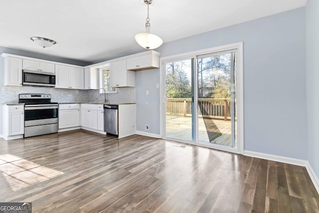 kitchen with stainless steel appliances and white cabinets