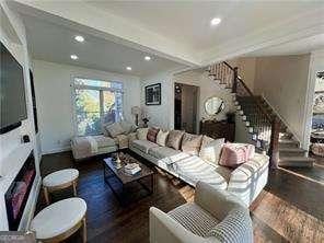 living room with dark hardwood / wood-style flooring