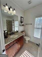 bathroom featuring tile patterned flooring, vanity, ornamental molding, a shower, and toilet