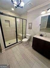 bathroom featuring walk in shower, toilet, crown molding, an inviting chandelier, and vanity