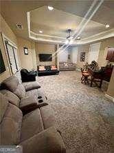 home theater featuring coffered ceiling and carpet